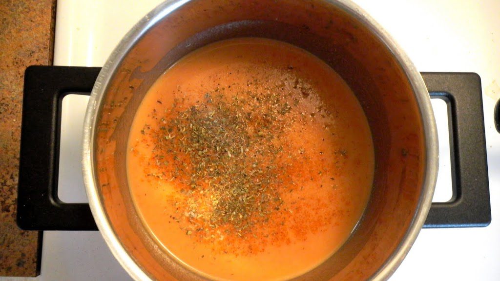 Tomato soup and ingredients in pot