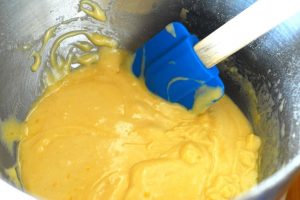 Creamy Madeleine Biscuit batter being stirred with a spatula
