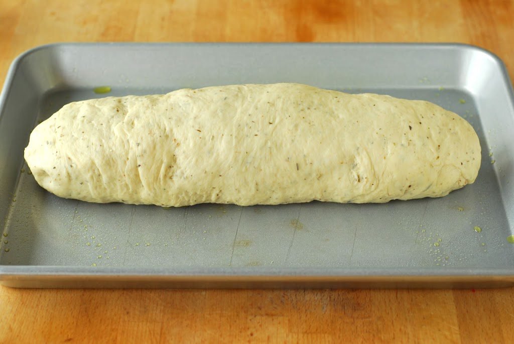 Bread dough shaped into loaf on cookie sheet