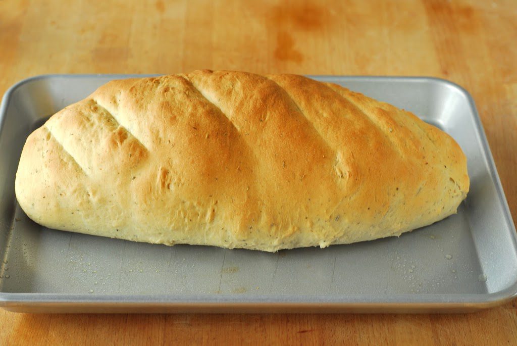Baked loaf of bread on cookie sheet