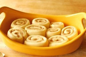 Yeast cinnamon rolls in a yellow baking dish