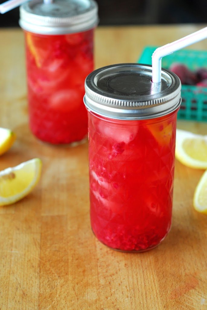 Raspberry Sun Tea and To-Go Mason Jars from A Duck's Oven. Delicious sun tea mixed with a raspberry puree, lemon, and honey makes a very refreshing beverage!