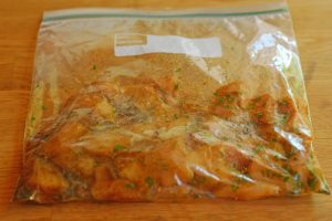 chicken marinating in a plastic bag