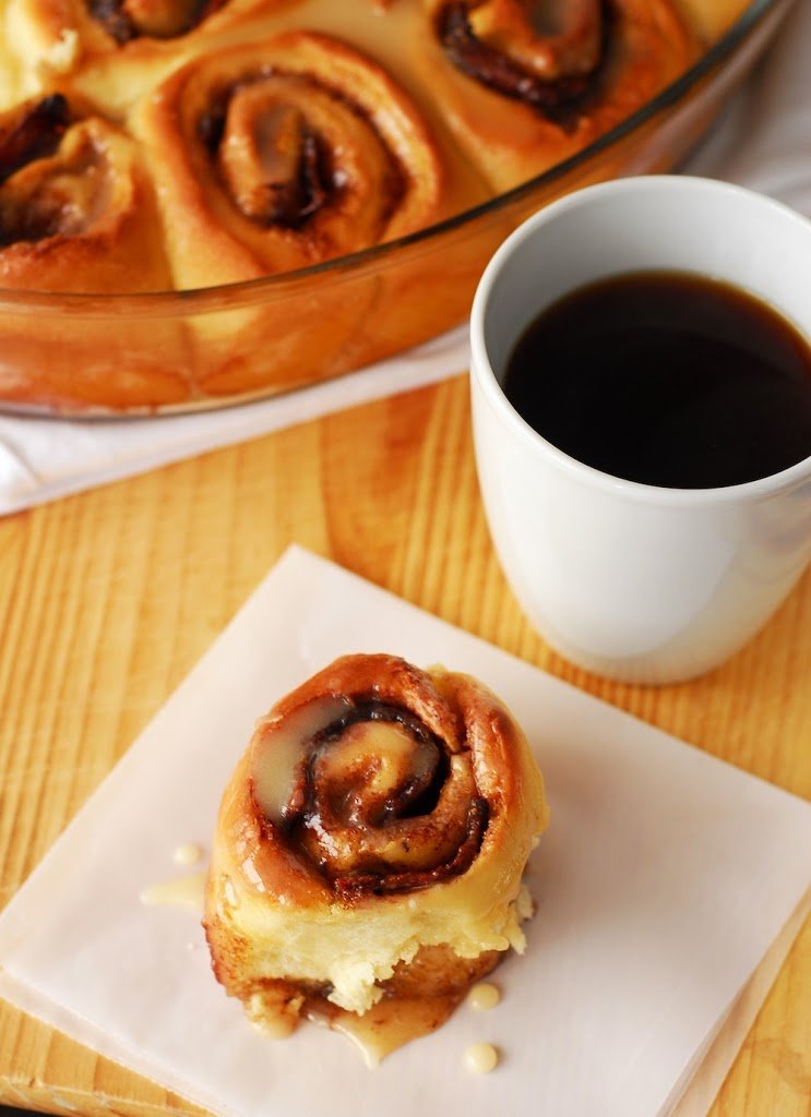 Bacon stuffed cinnamon roll with cup of coffee