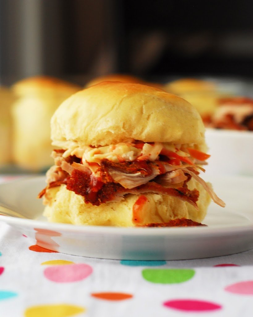 Pulled pork slider on white plate on polka dotted towel