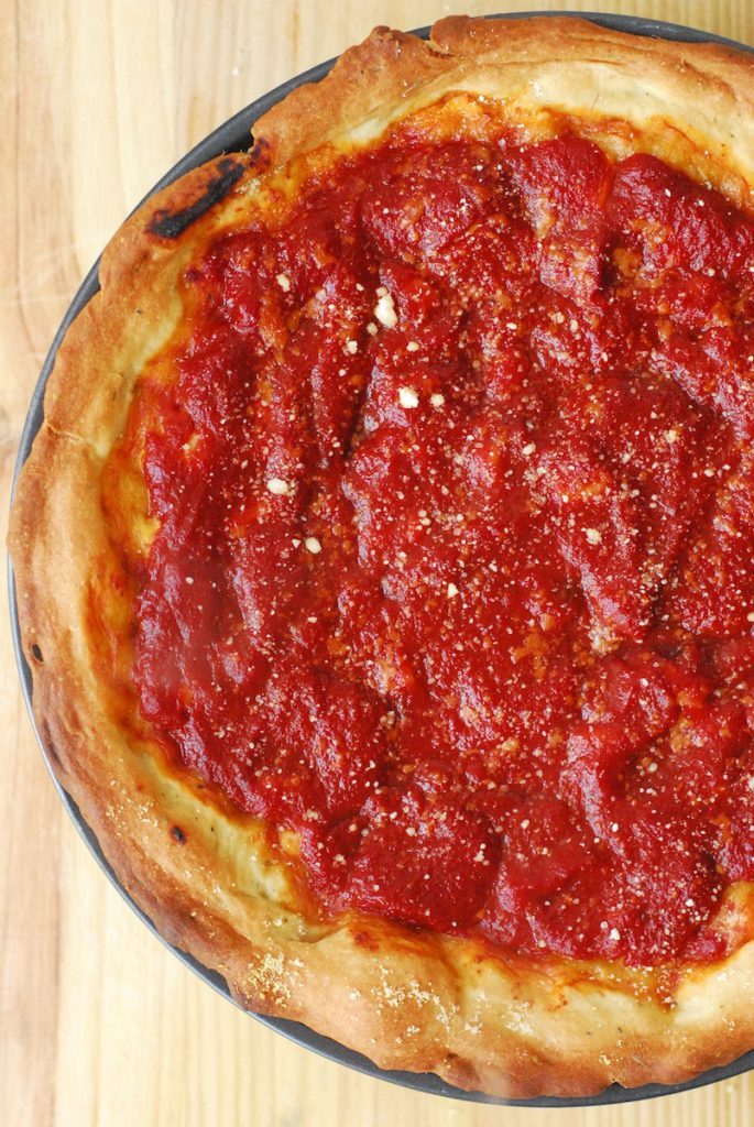 Chicago-Style Deep Dish Pizza from A Duck's Oven. Deep dish pizza with the fillings on the bottom, cheese in the middle, and plenty of tomato sauce on top!