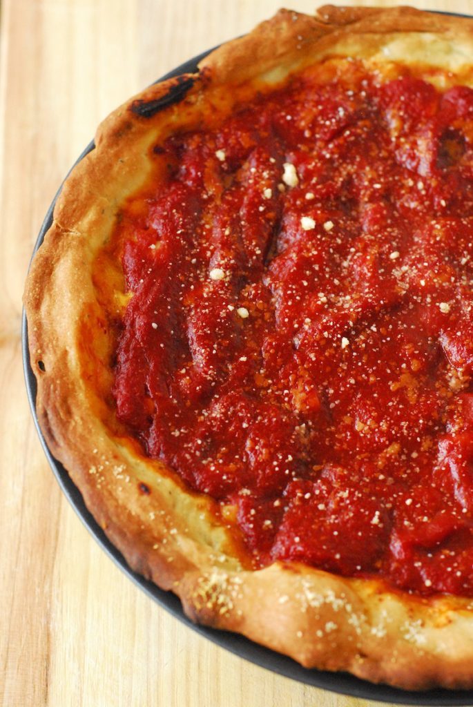 Chicago-Style Deep Dish Pizza from A Duck's Oven. Deep dish pizza with the fillings on the bottom, cheese in the middle, and plenty of tomato sauce on top!