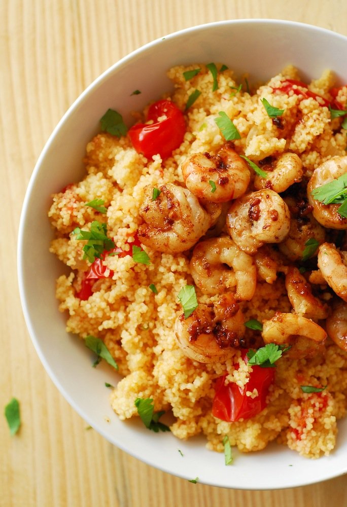 Spicy Shrimp and Couscous from A Duck's Oven. Shrimp seared in butter, lemon, and garlic over couscous cooked with jalapeños & grape tomatoes. Ready in 15 minutes!