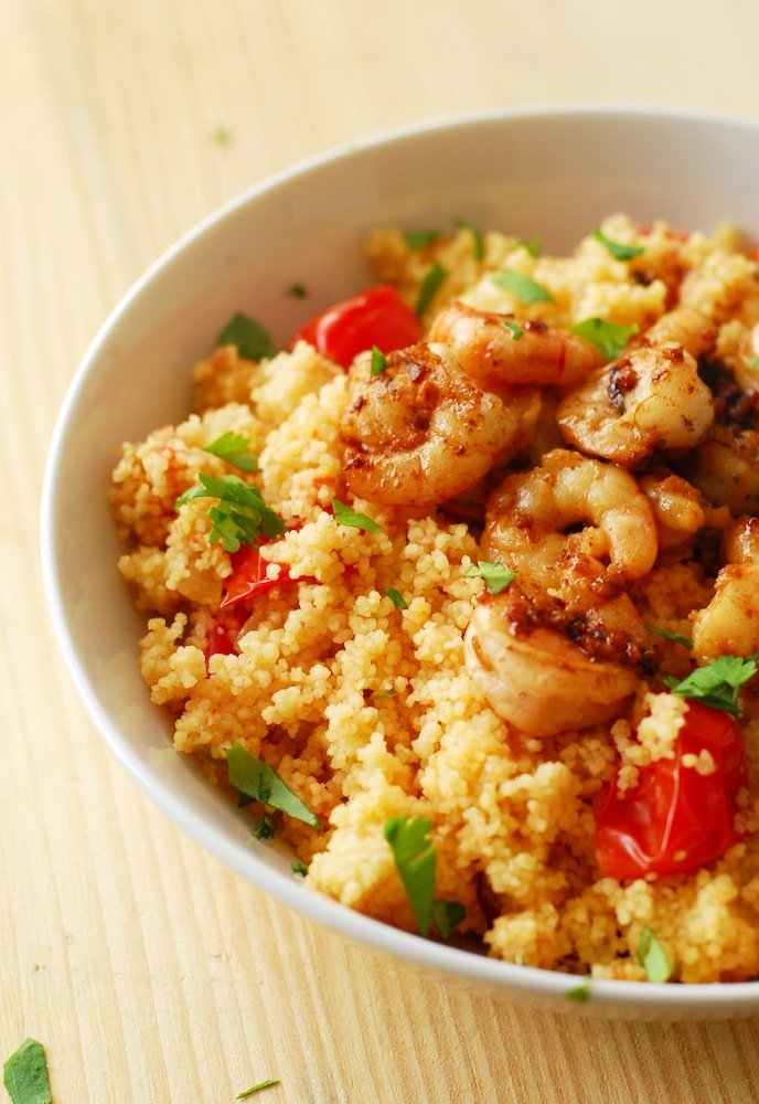 Spicy Shrimp and Couscous from A Duck's Oven. Shrimp seared in butter, lemon, and garlic over couscous cooked with jalapeños & grape tomatoes. Ready in 15 minutes!