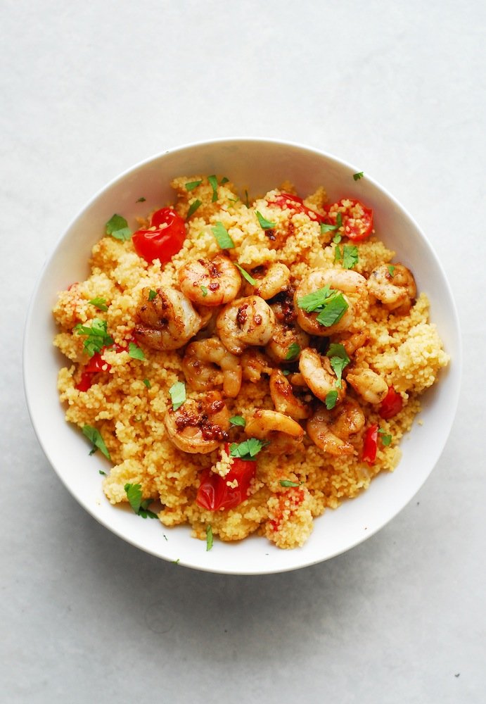 Spicy Shrimp and Couscous from A Duck's Oven. Shrimp seared in butter, lemon, and garlic over couscous cooked with jalapeños & grape tomatoes. Ready in 15 minutes!