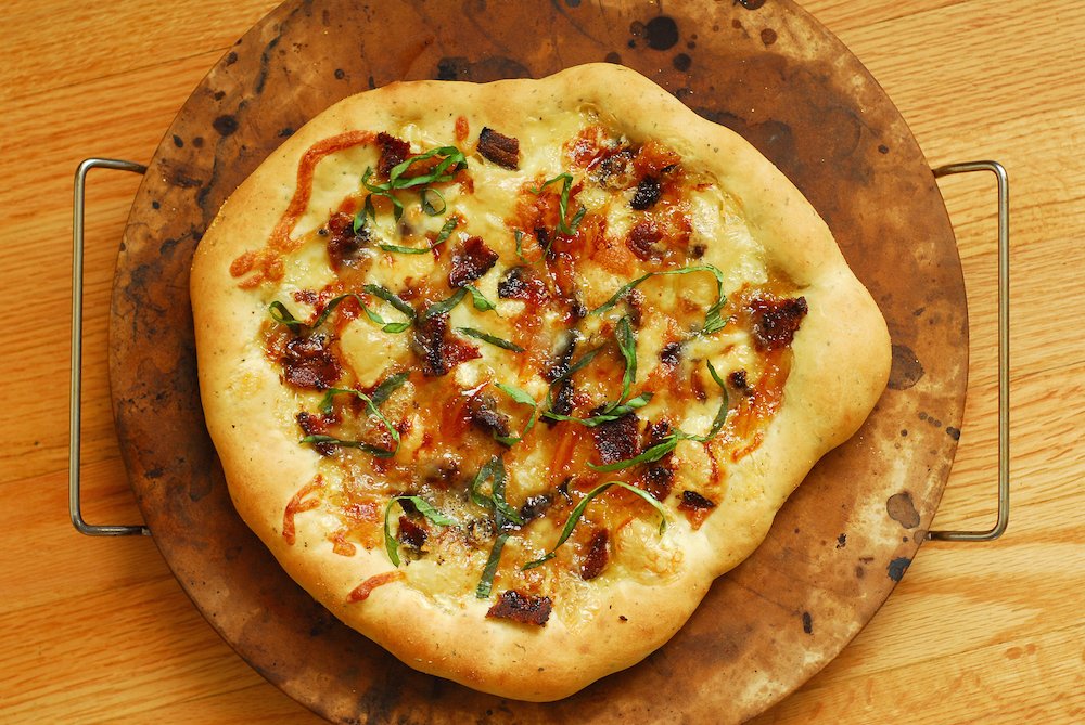 Brie, Bacon, and Orange Pizza with Truffle Oil from A Duck's Oven. The perfect salty + sweet combo that's fancy but not too difficult to make!