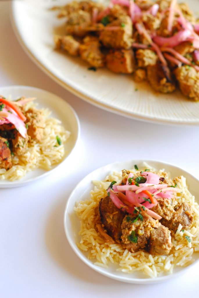 Slow Cooker Haitian Pork from A Duck's Oven. Simple, bright pork slow cooked all day long then served on a bed of rice and topped with pickled veggies.