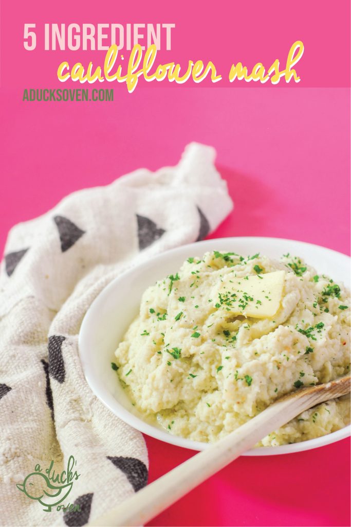A bowl of mashed cauliflower with butter and parsley