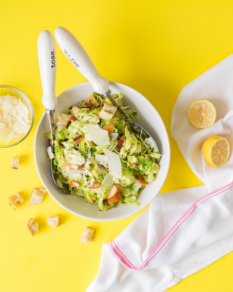 Warm brussels sprouts salad on yellow surface