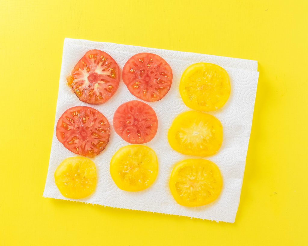 Salted tomatoes on a paper towel to pull out excess moisture