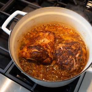 Pork shanks in braising liquid in dutch oven