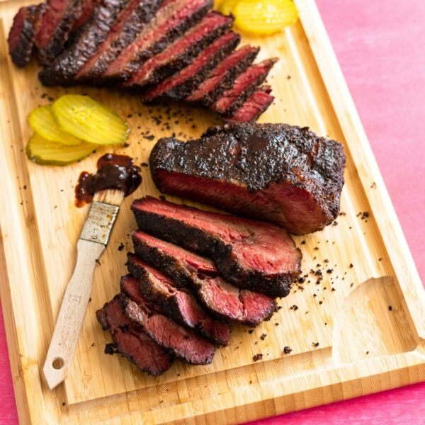 Sous vide beef brisket sliced on wood cutting board