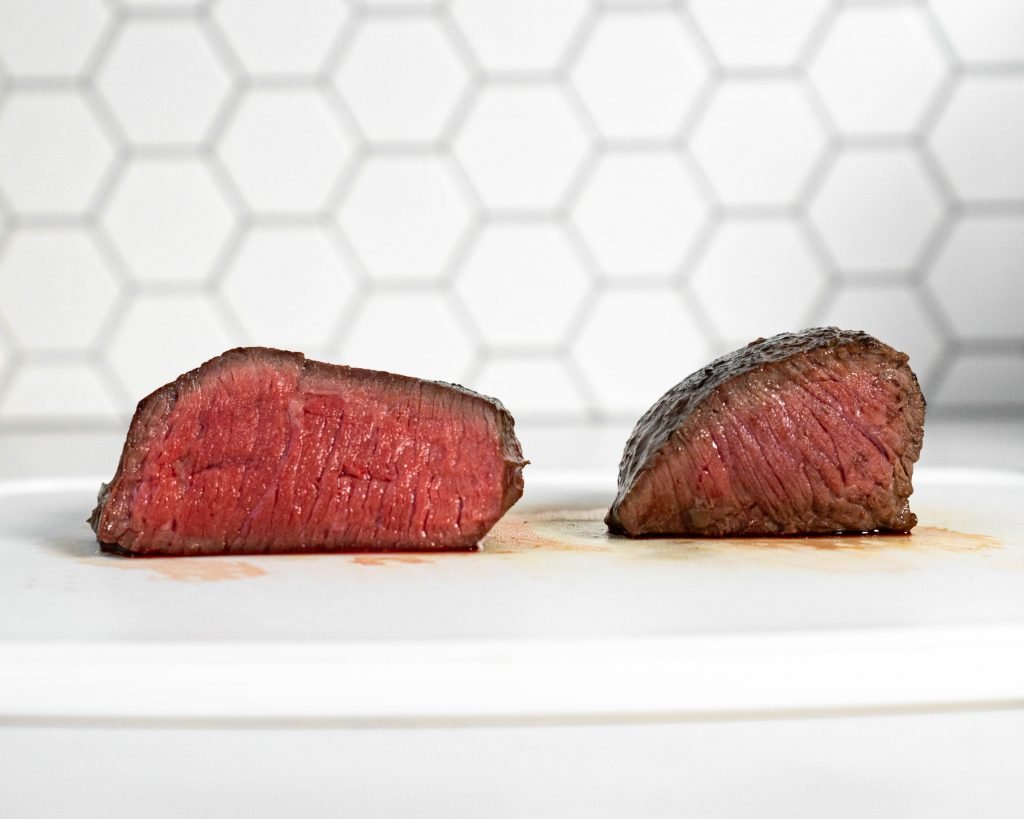 Photo comparing a sous vide steak and a pan seared steak