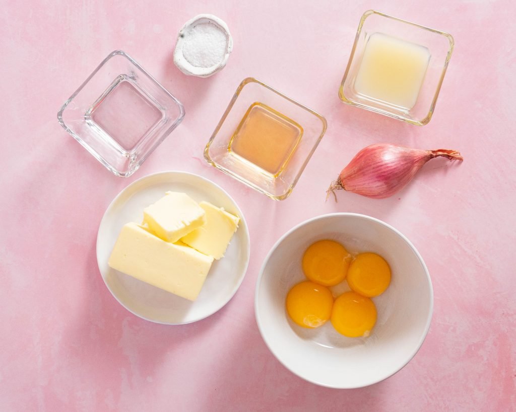 Hollandaise ingredients on pink surface