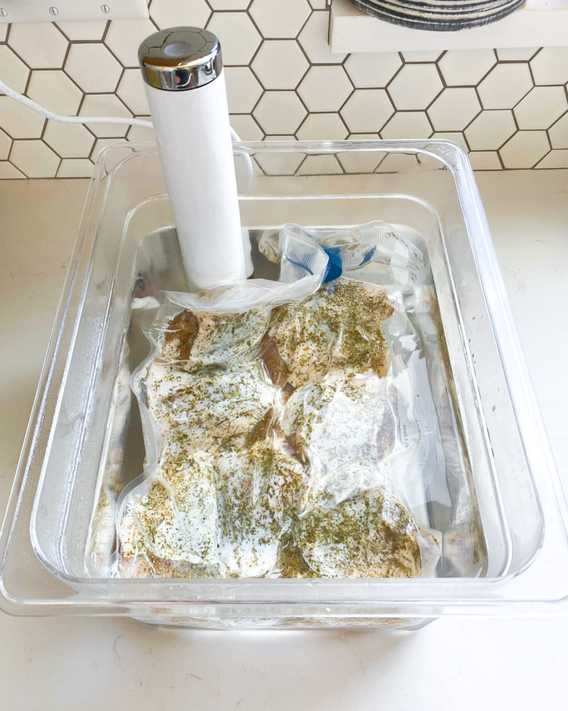 Chicken thighs vacuum sealed and in a sous vide water bath on kitchen counter