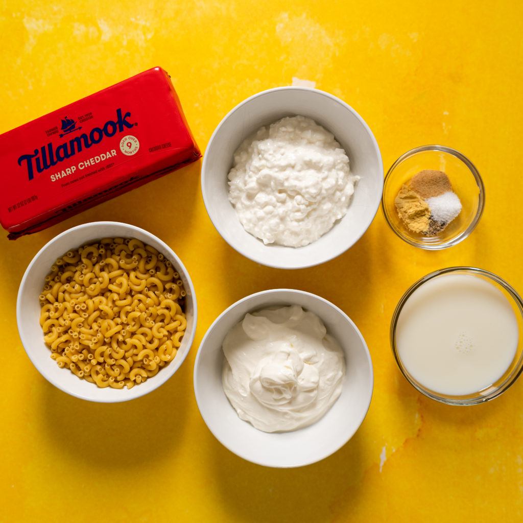 Ingredients for mac and cheese without flour on yellow surface