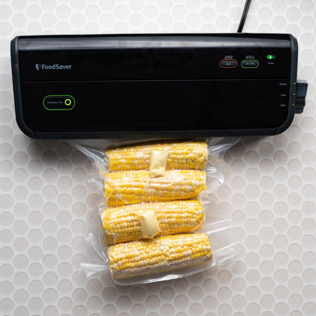 Corn and butter being vacuum sealed