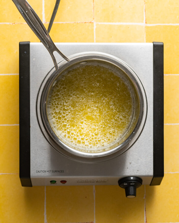 Foaming melted butter in pot.