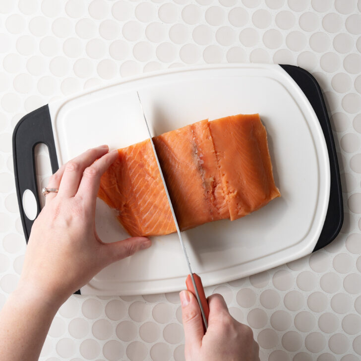 Cutting the salmon into smaller portions.